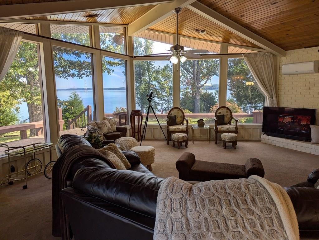 a large bedroom with furniture and large windows