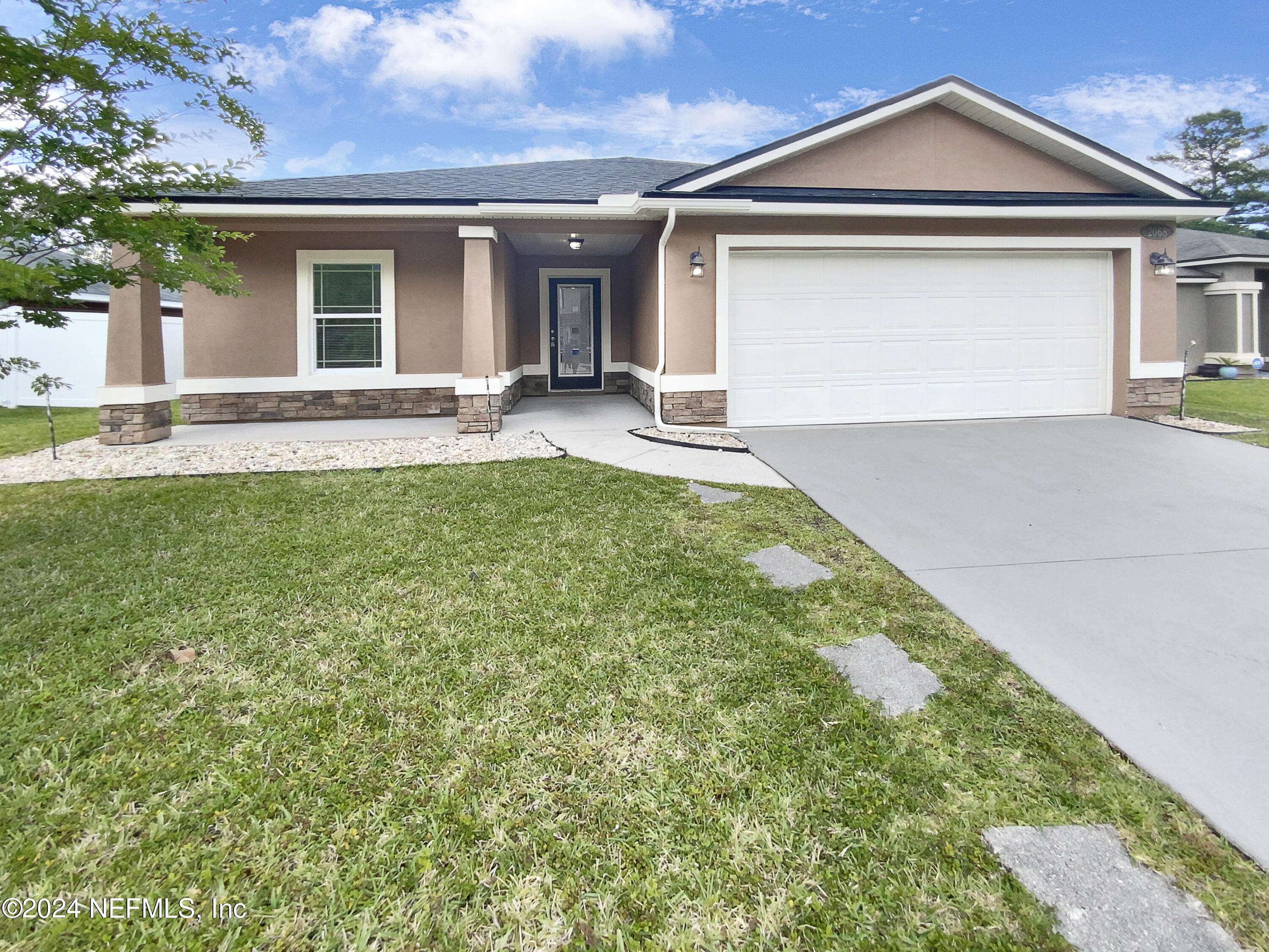 a front view of a house with a yard