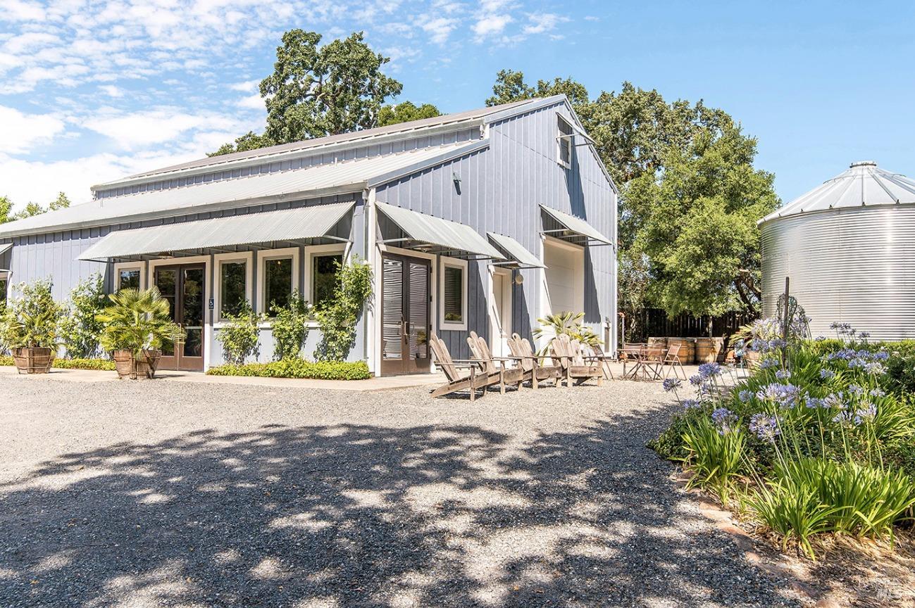 a view of a house with backyard sitting area and porch