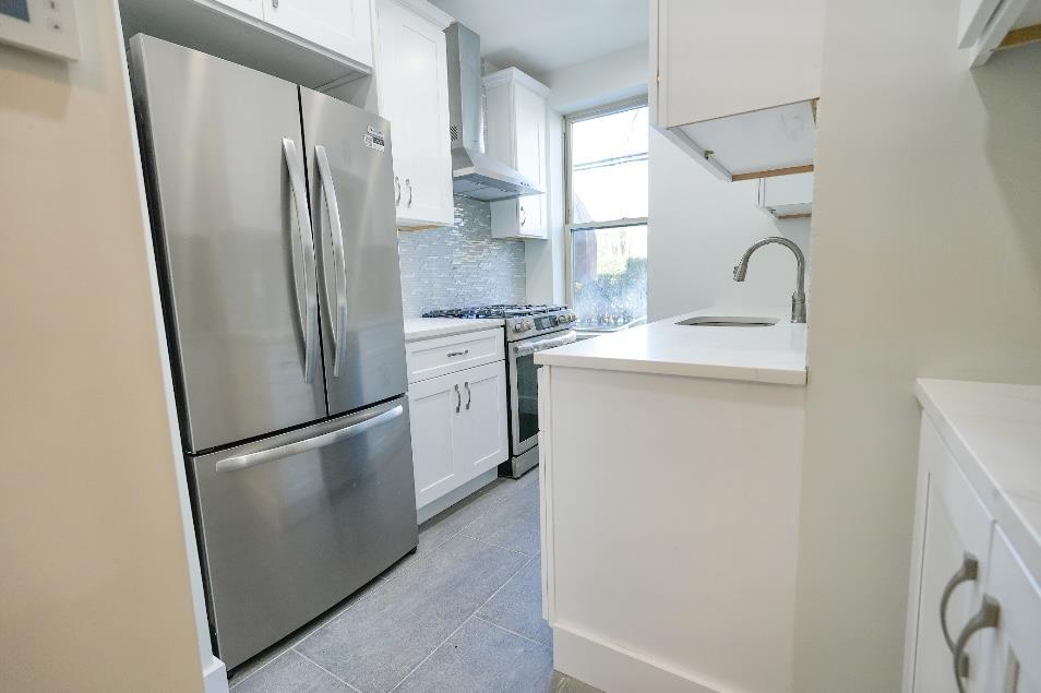 a kitchen with stainless steel appliances a refrigerator a sink and a stove