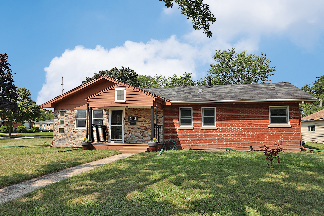 a front view of house with yard and green space