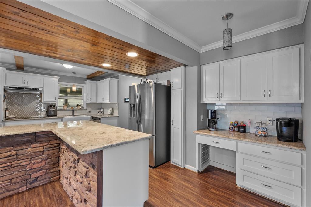 a kitchen with a refrigerator a sink and cabinets