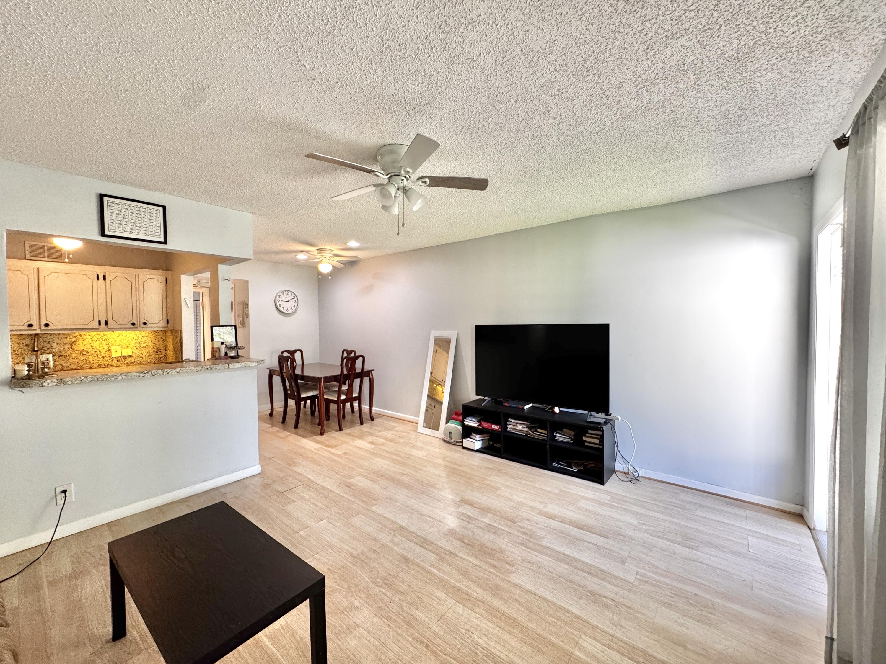 a view of a livingroom with furniture and a flat screen tv