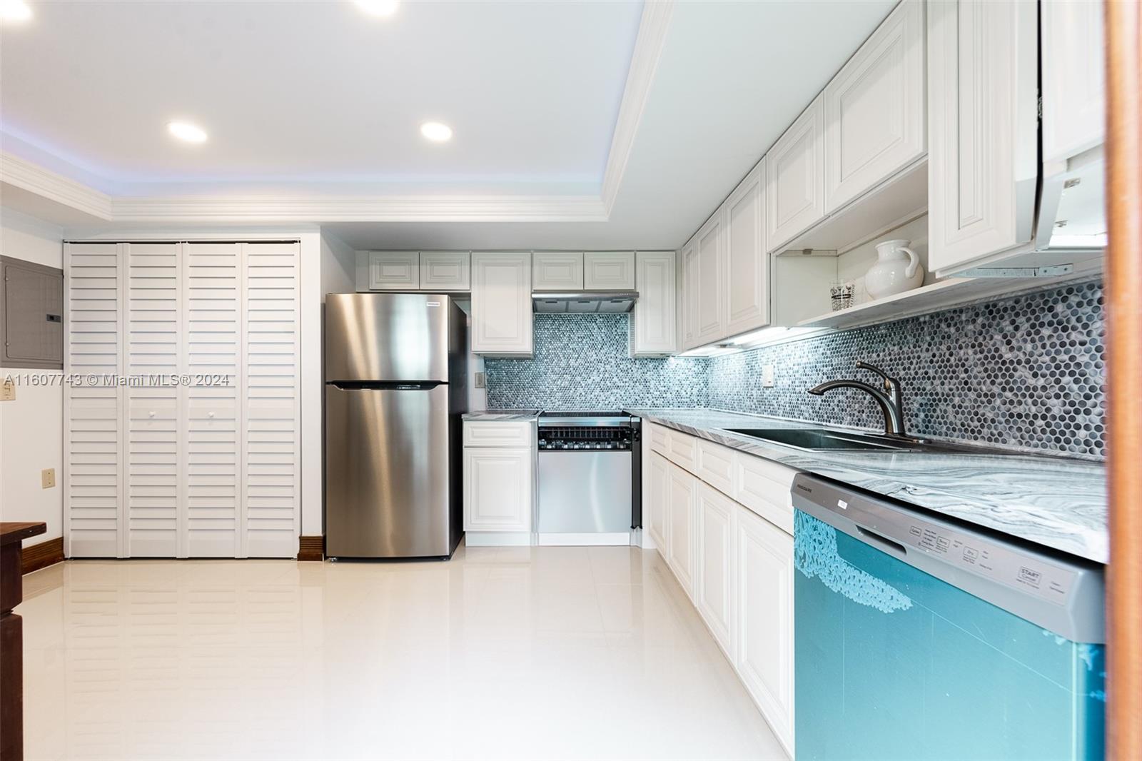 a kitchen with a refrigerator and a sink