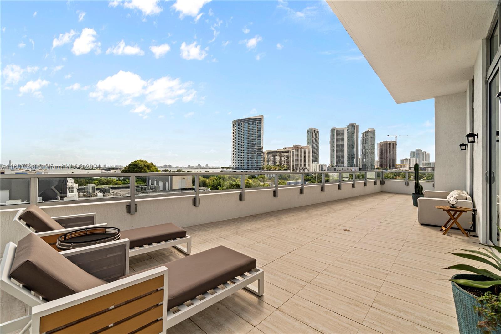 a terrace with outdoor seating and city view