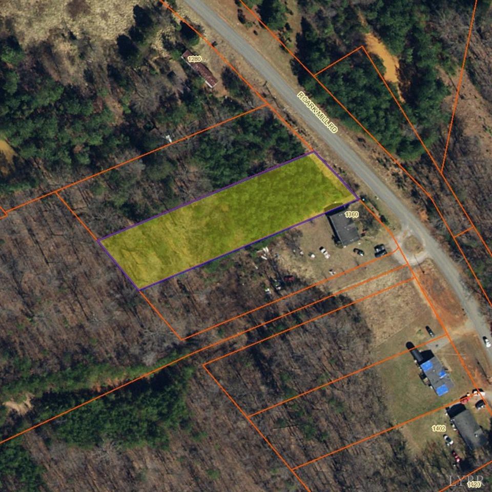 a view of a yard with wooden fence