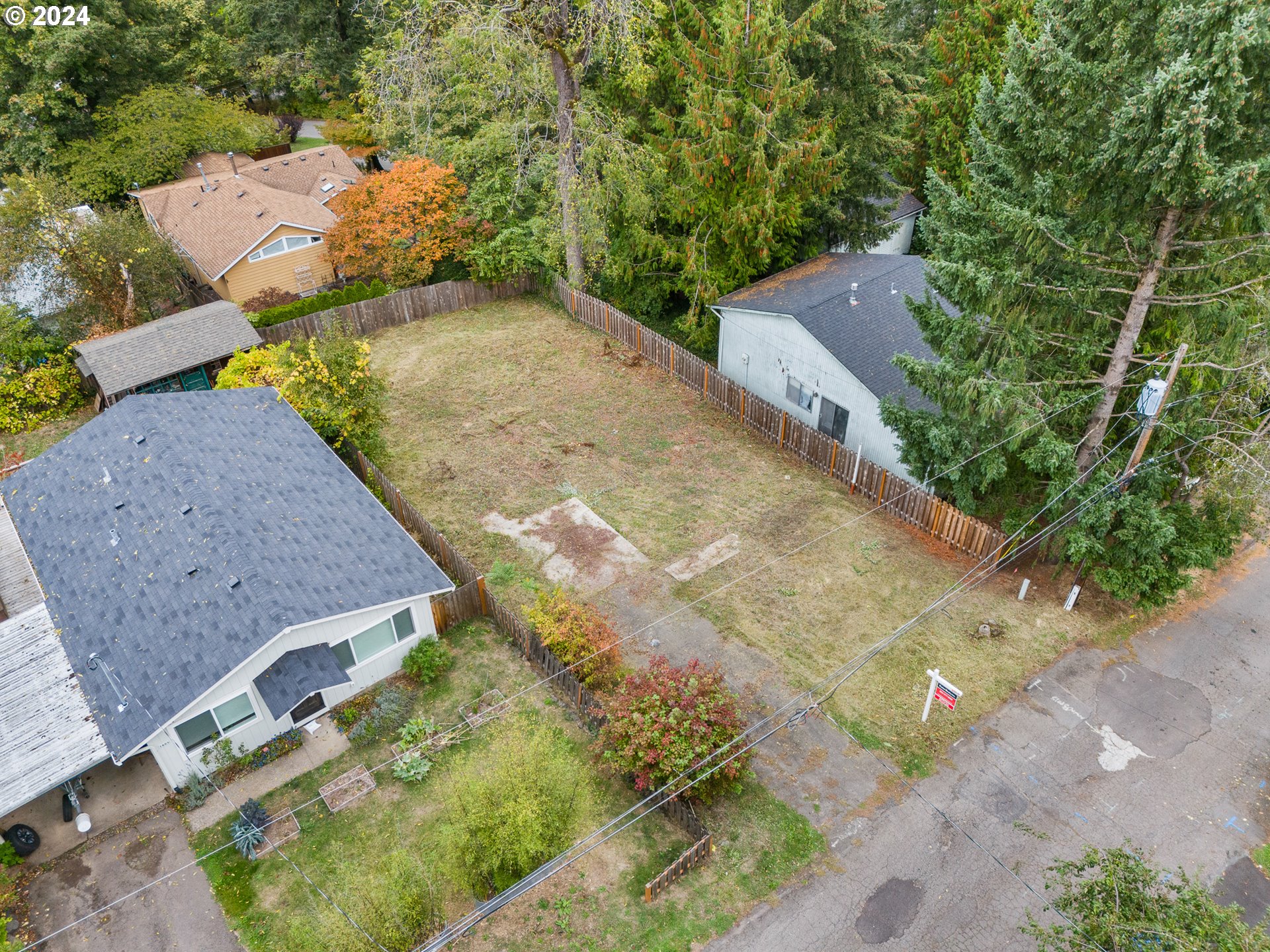 an aerial view of a house with a yard and greenery