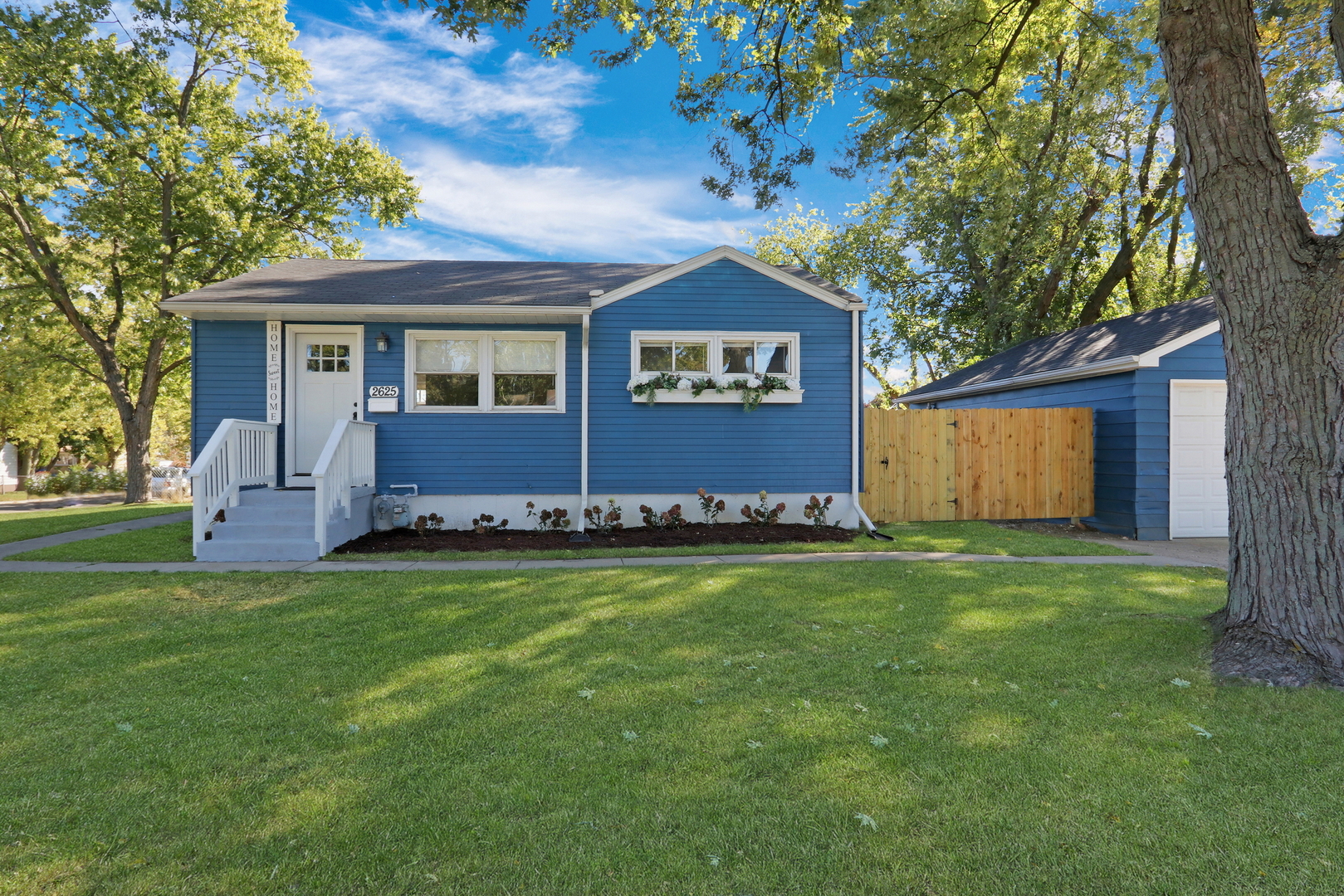 a front view of house with yard and trees