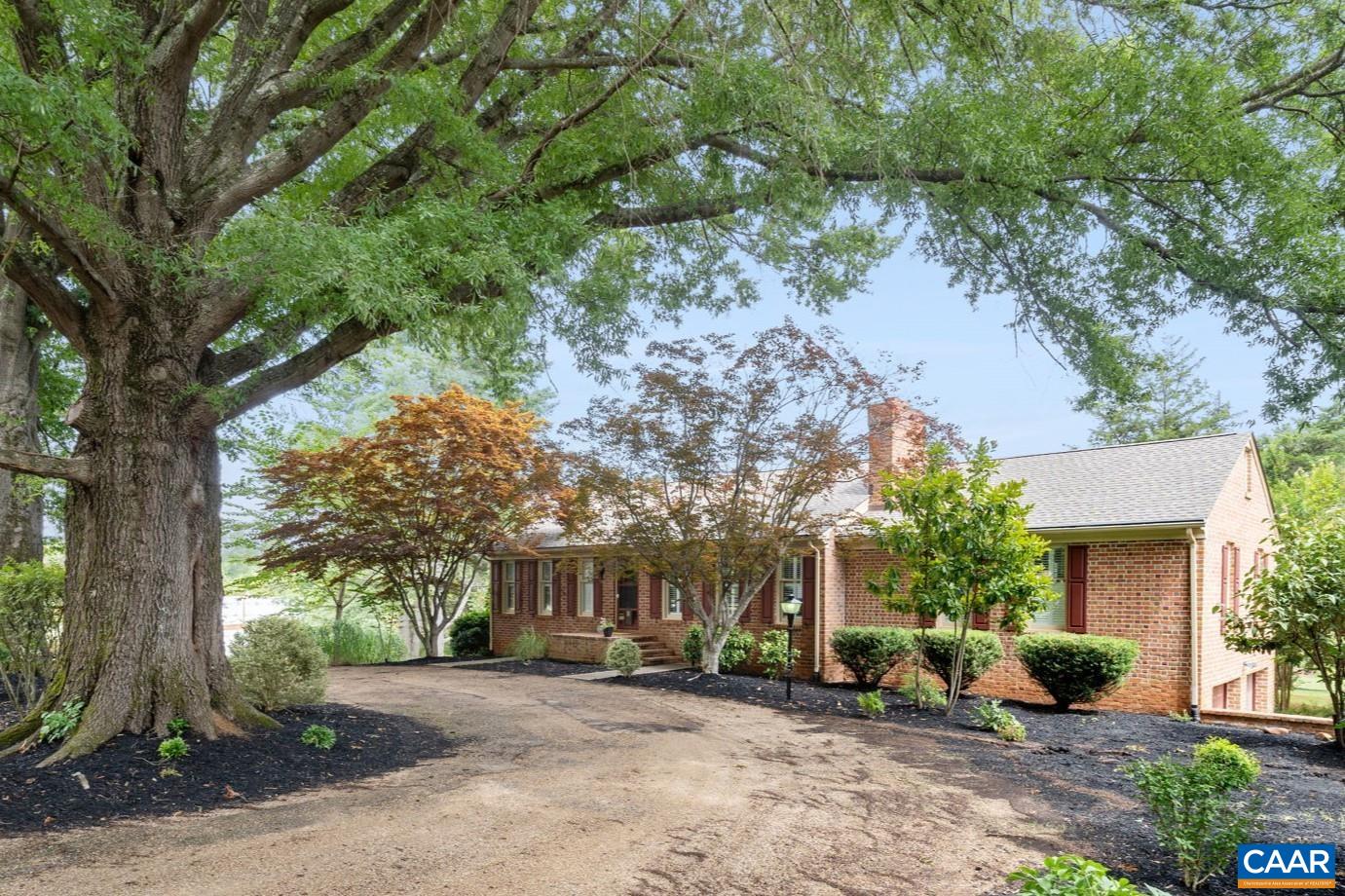 a view of a house with a tree in front