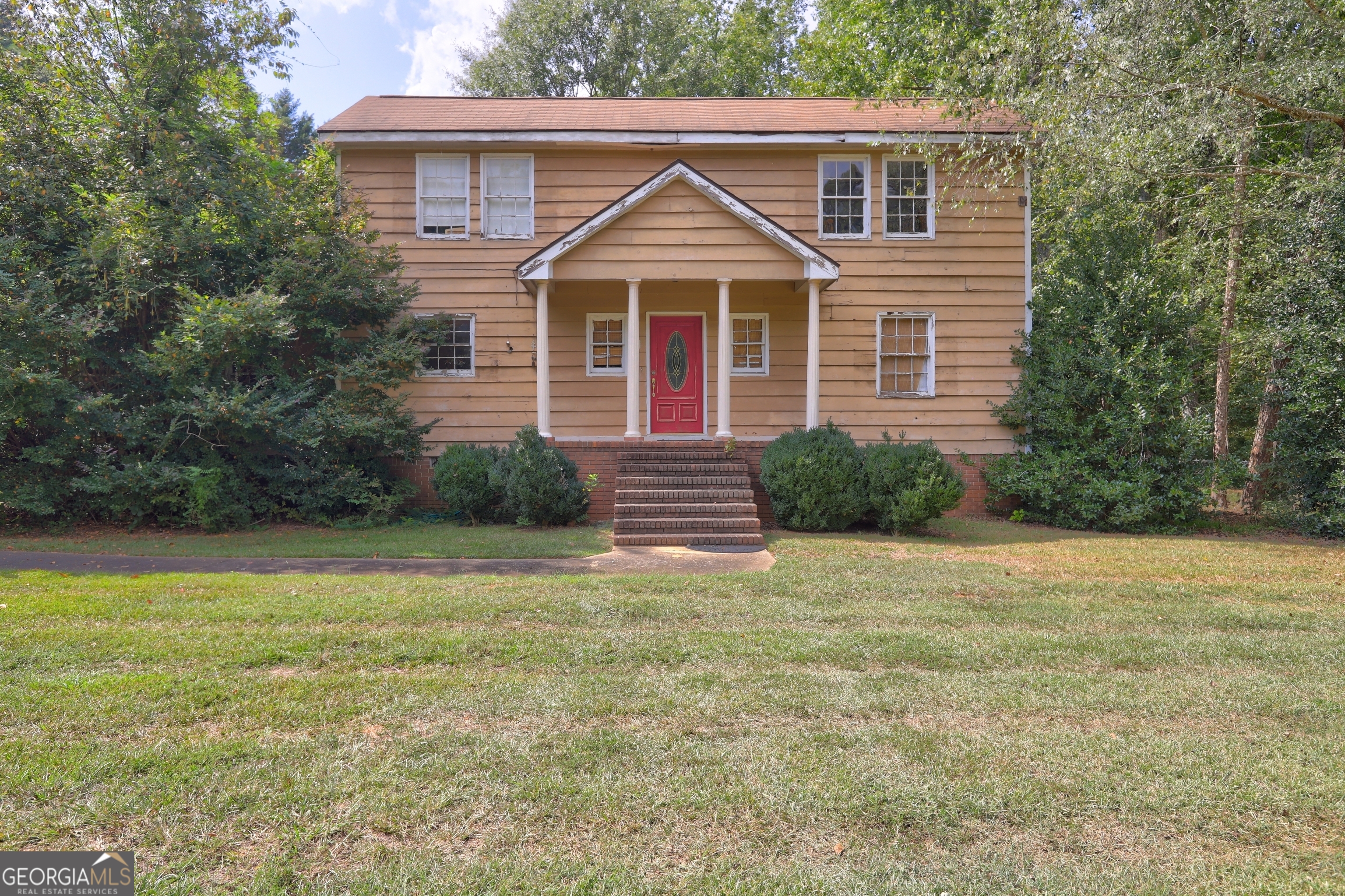 a front view of a house with garden