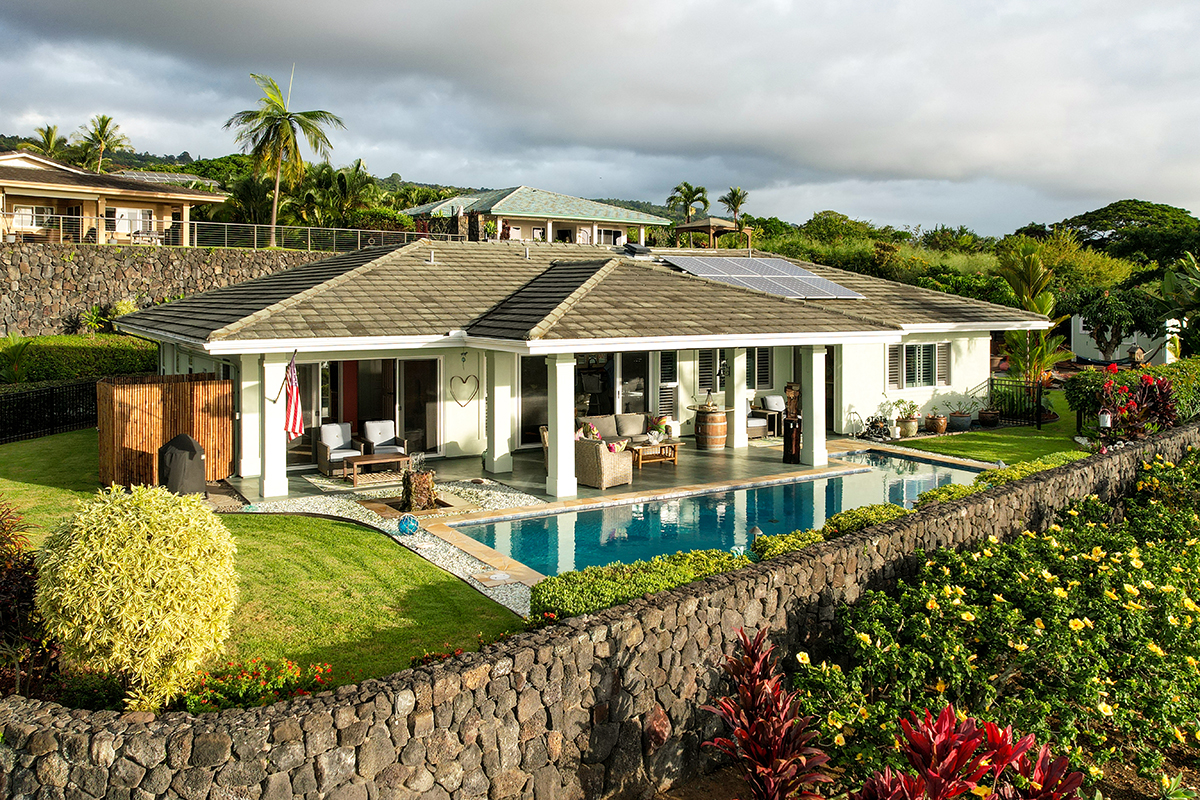 a view of a house with swimming pool and sitting area