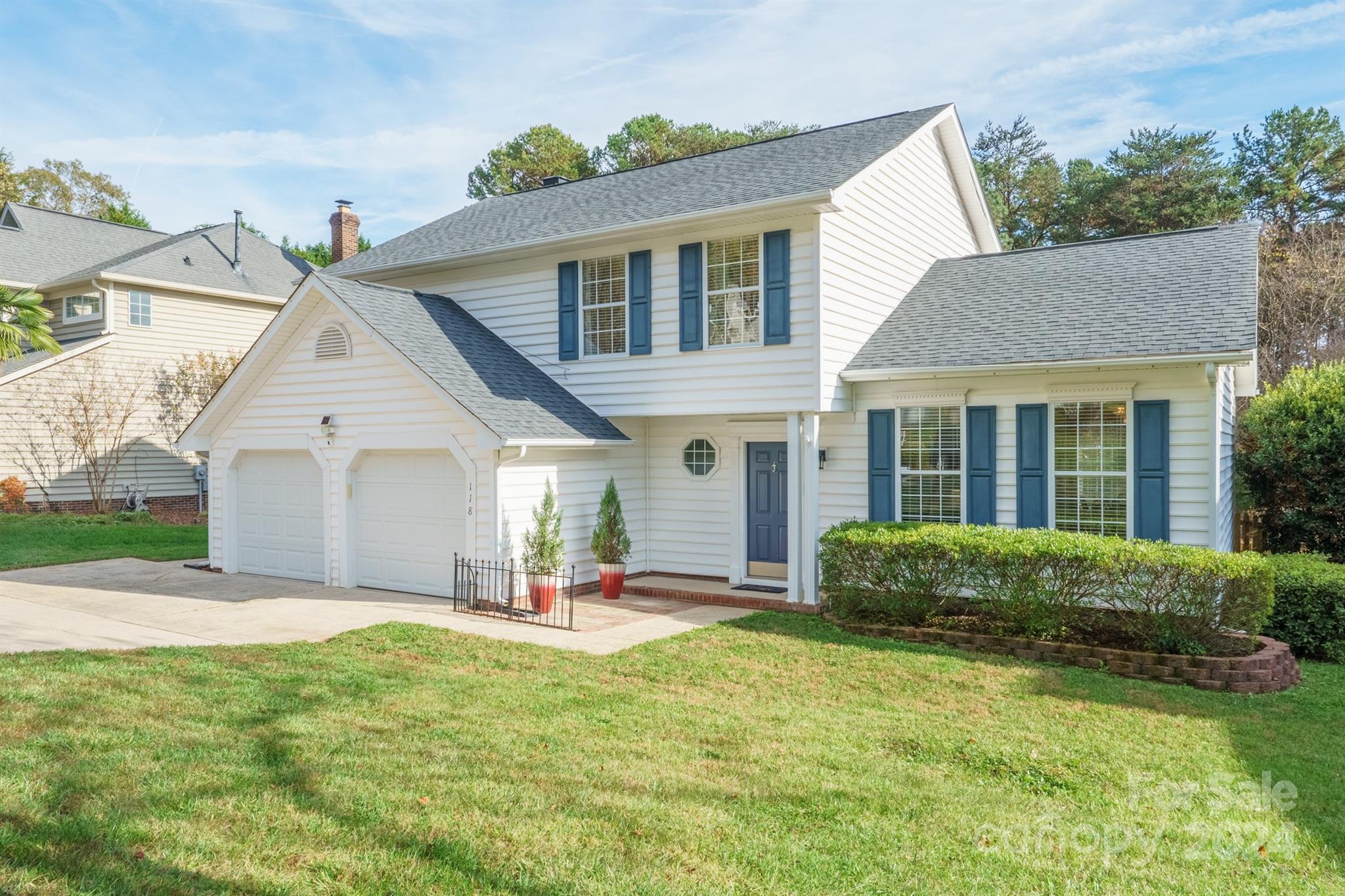 a front view of a house with a yard and porch