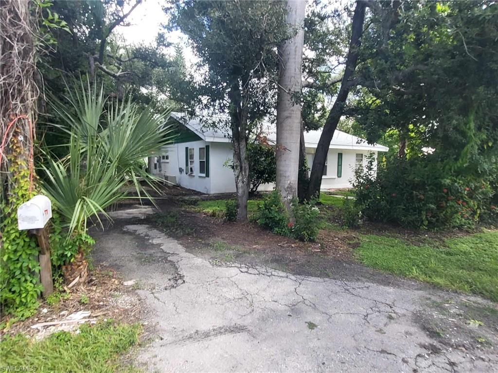 a view of a house with a tree in the yard