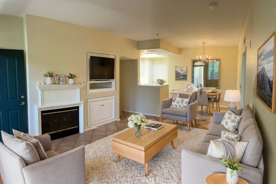 a living room with furniture flat screen tv and a fireplace