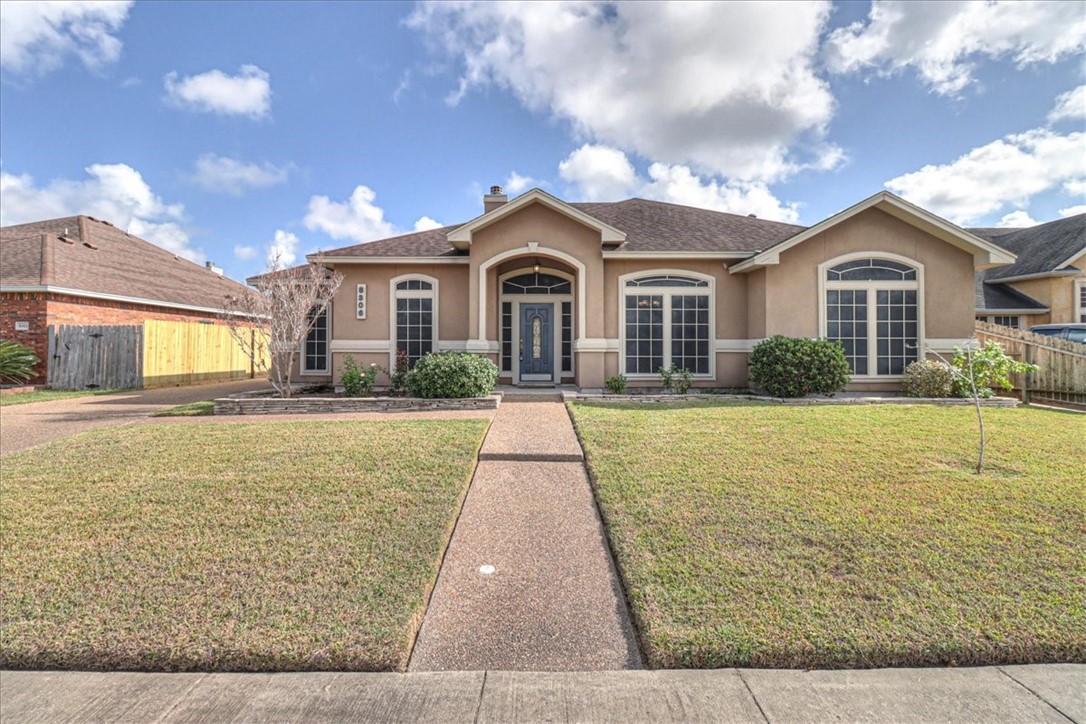 a view of a brick house with a yard