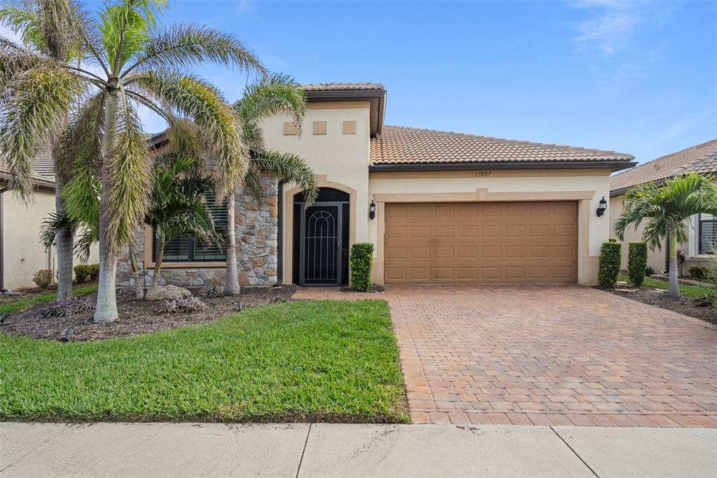 a front view of a house with a yard and garage