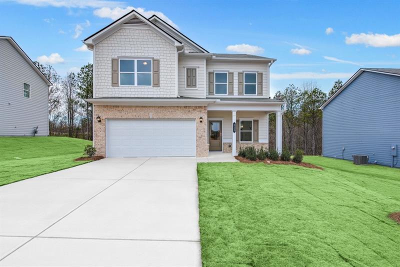 a front view of a house with a yard