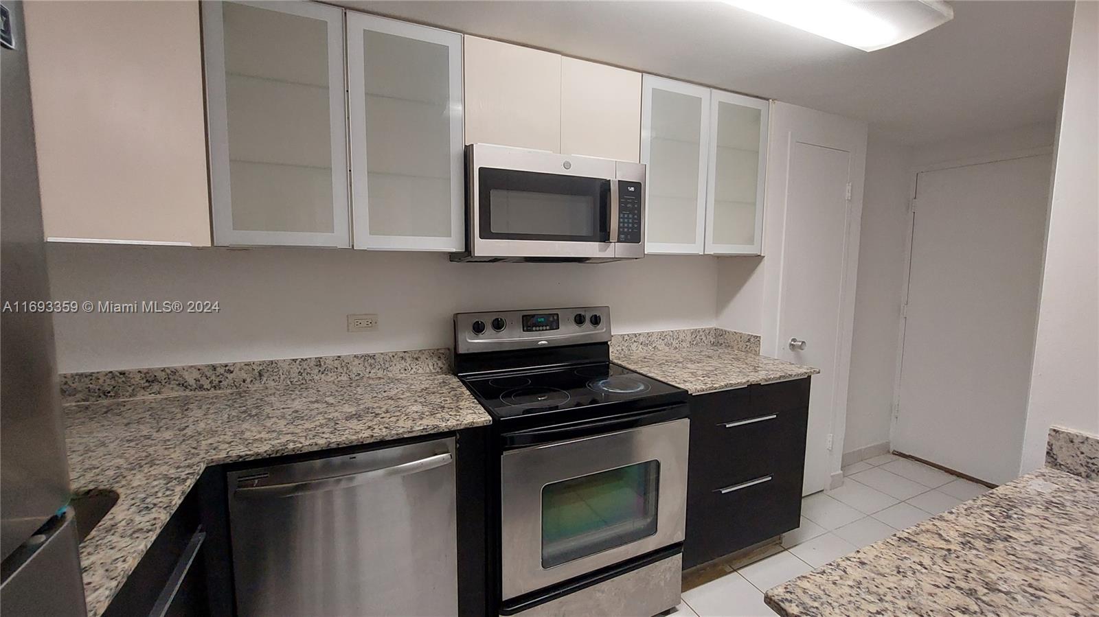 a kitchen with stainless steel appliances granite countertop a stove microwave and sink