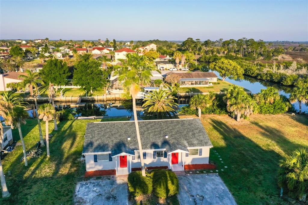 an aerial view of residential houses with outdoor space