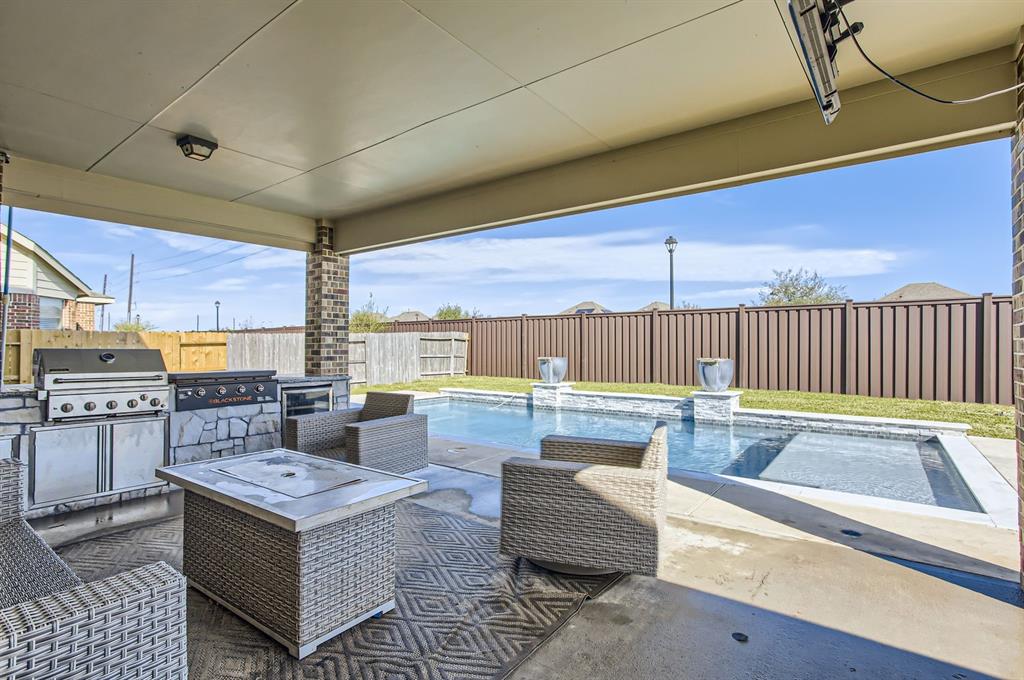 a living room with stainless steel appliances kitchen island granite countertop furniture and a kitchen view