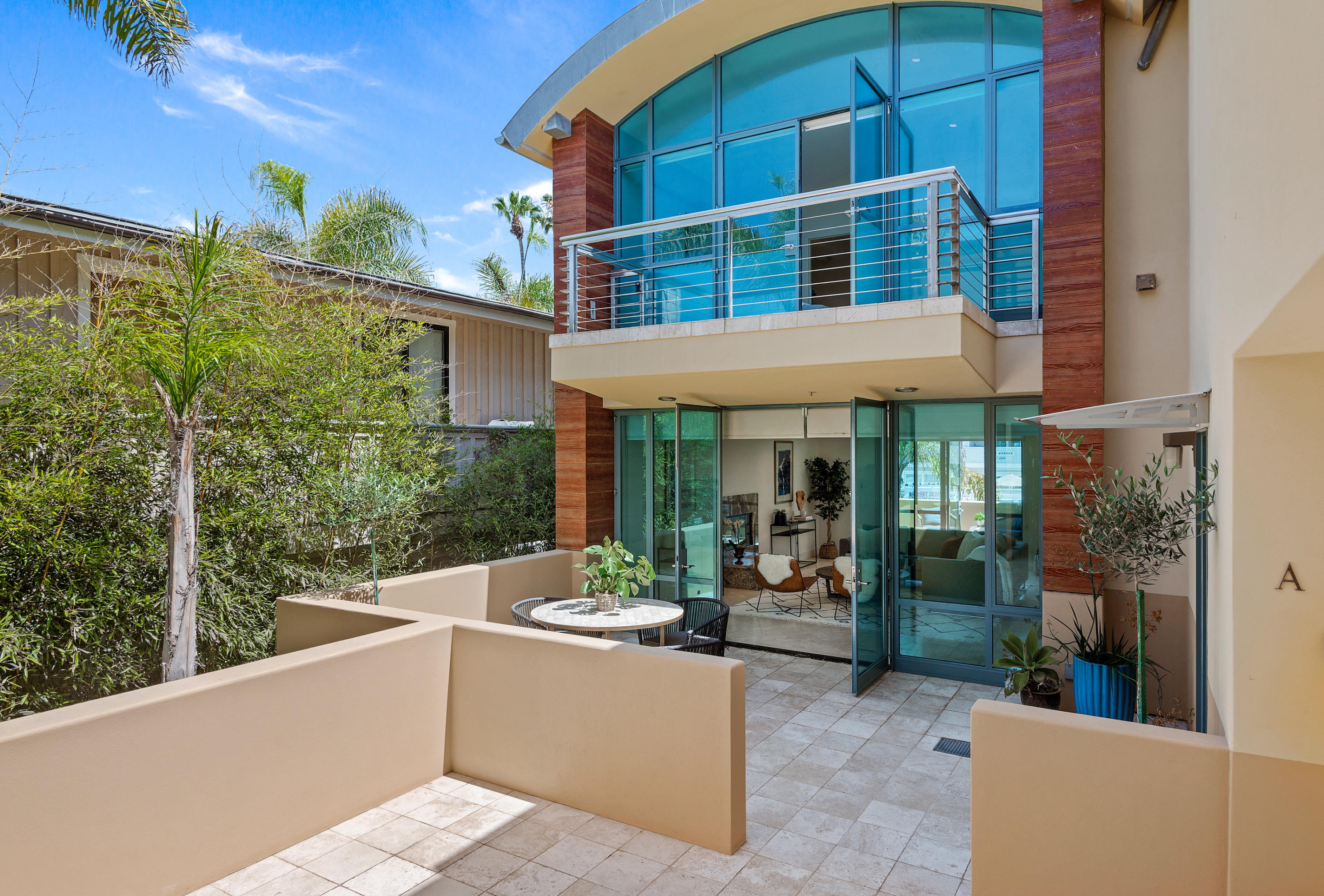 a view of a patio with a table and chairs and potted plants