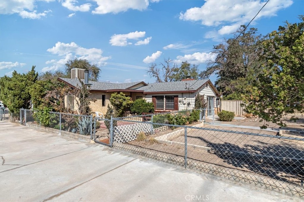 a view of a house with a yard and a patio