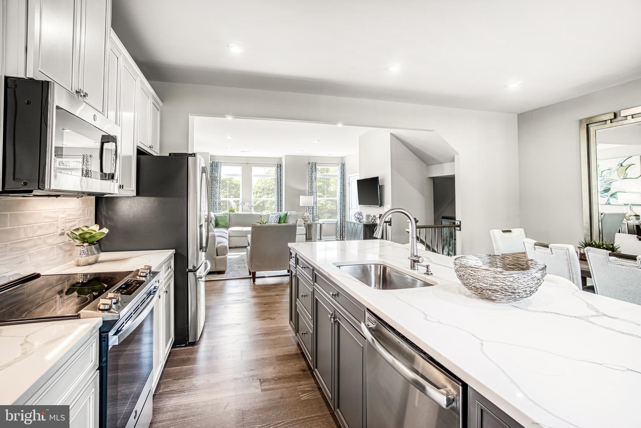 a kitchen with counter top space a sink cabinets and stainless steel appliances