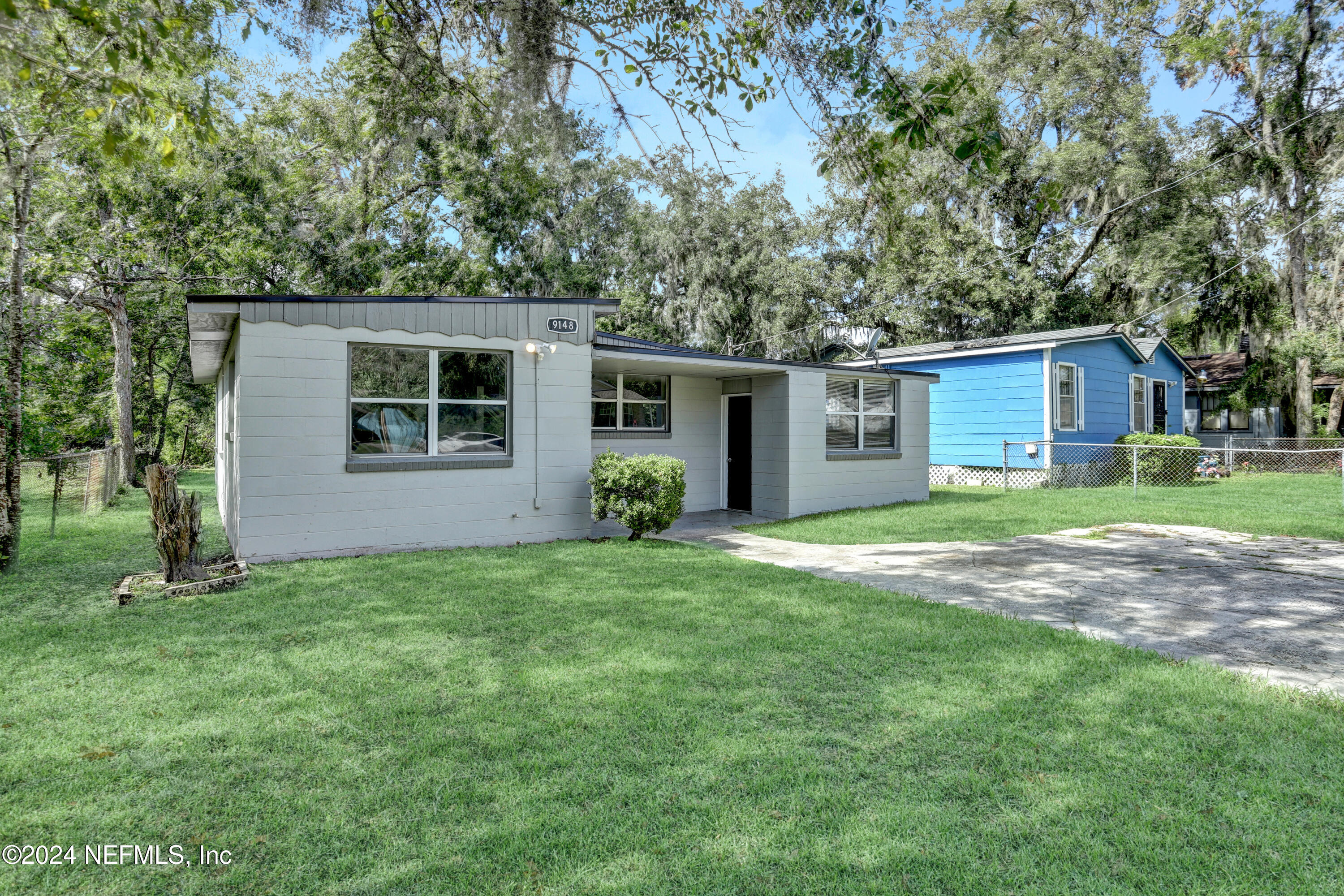 front view of a house with a yard and trees