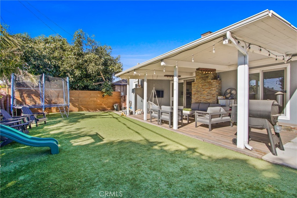 a view of a house with a yard patio and swimming pool