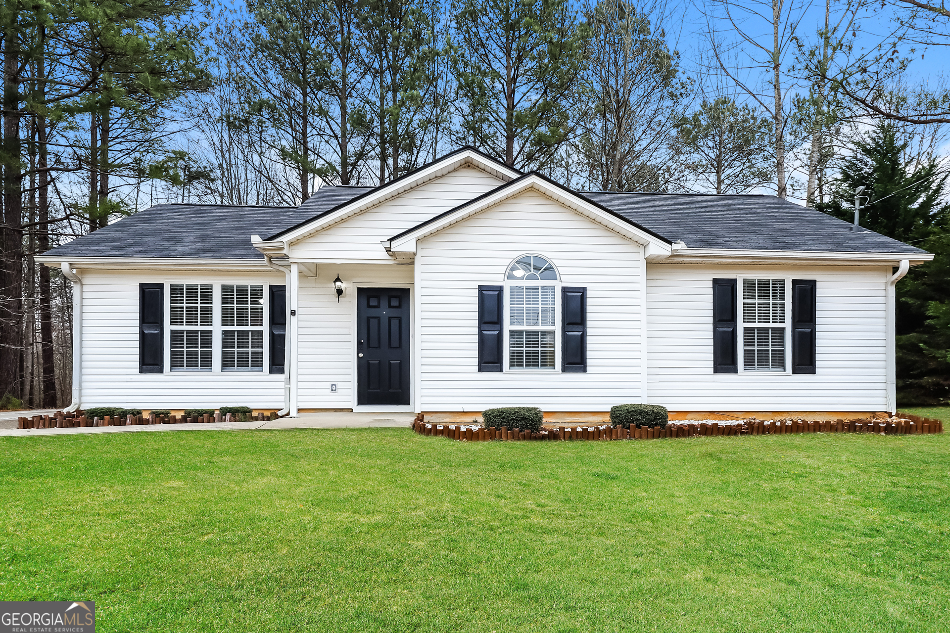 a front view of house with yard and green space