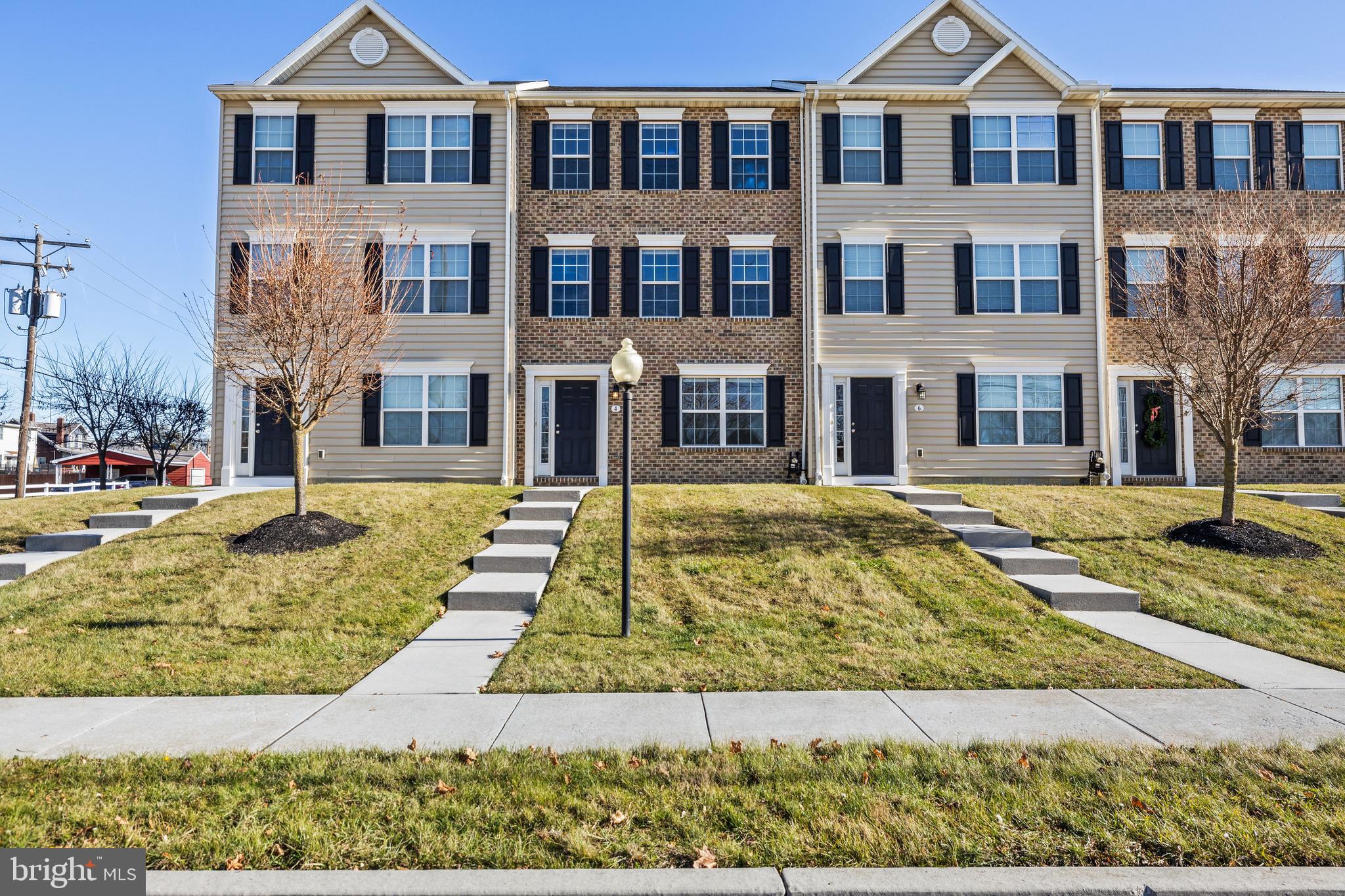 a front view of a residential apartment building with a yard