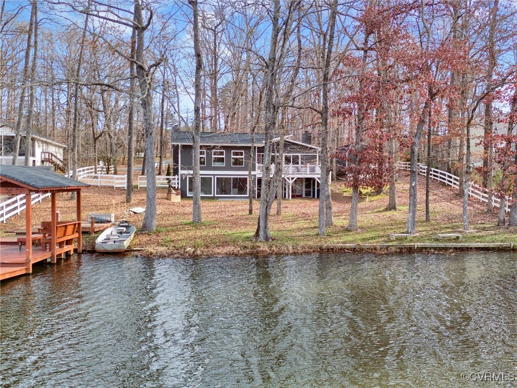 View of dock featuring a deck with water view and