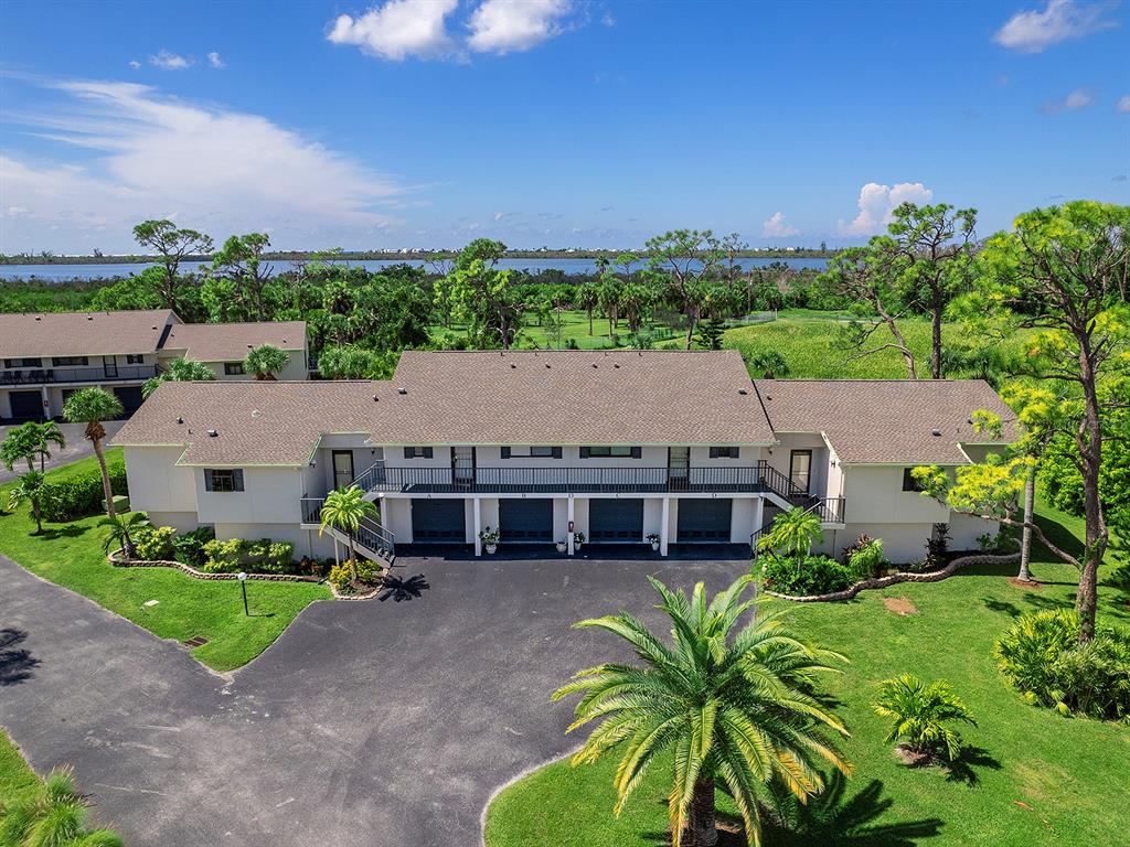 an aerial view of a house with a garden and trees