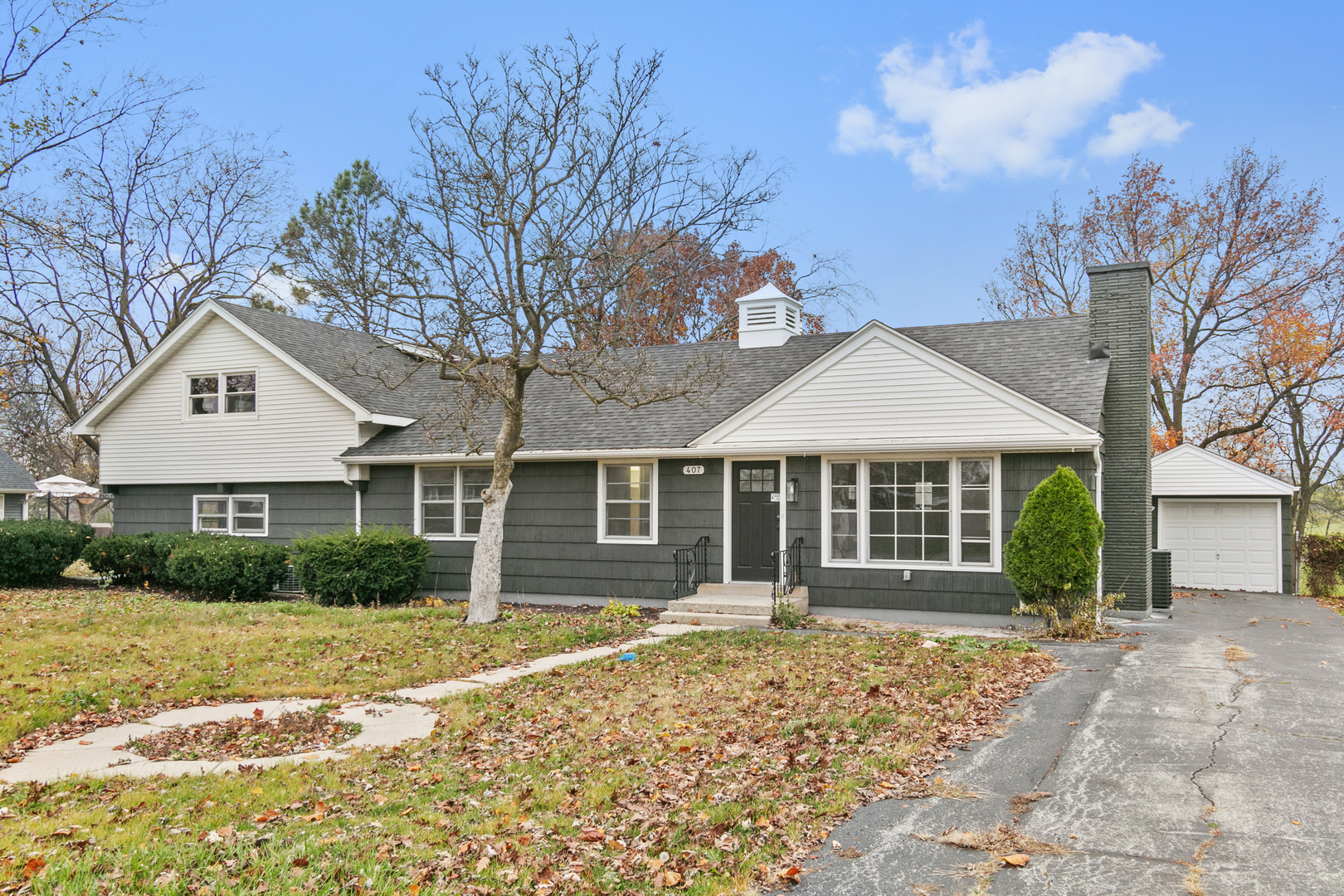 a front view of a house with a garden