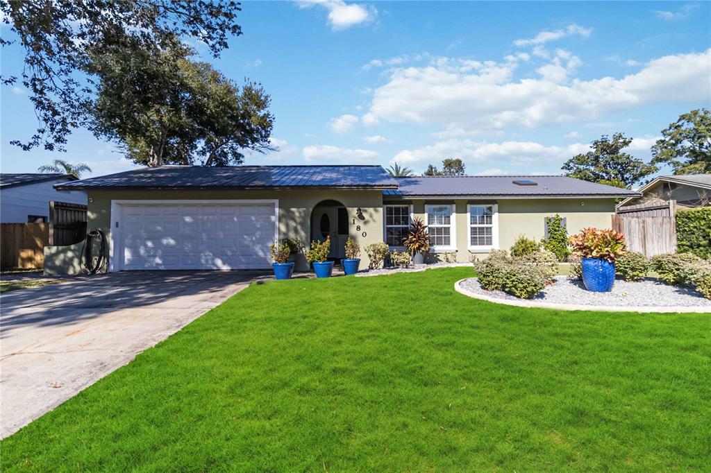 a front view of a house with garden