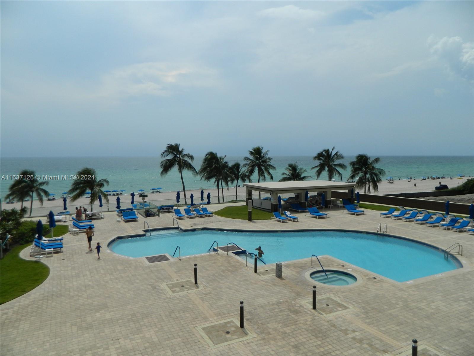 an outdoor space with swimming pool and furniture