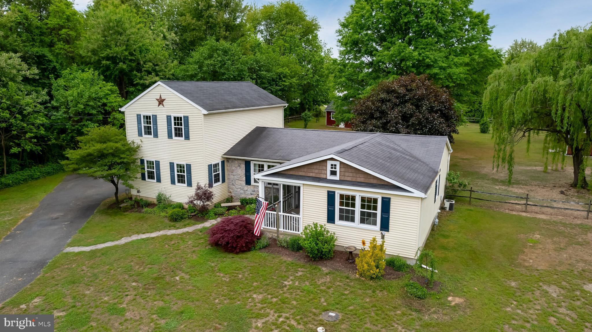 a aerial view of a house with swimming pool next to a yard