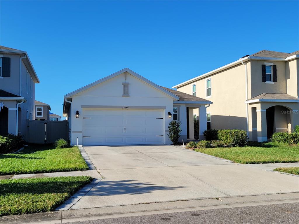 a front view of a house with a yard and garage