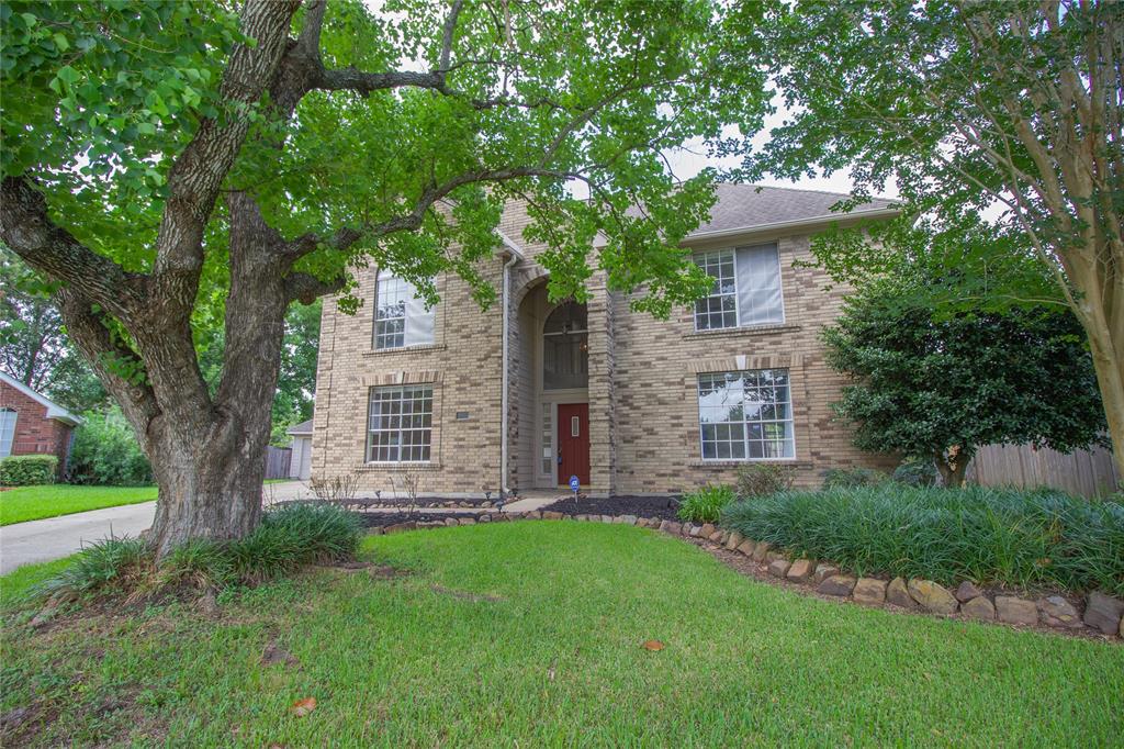 Front of the home with loads of Greenery.