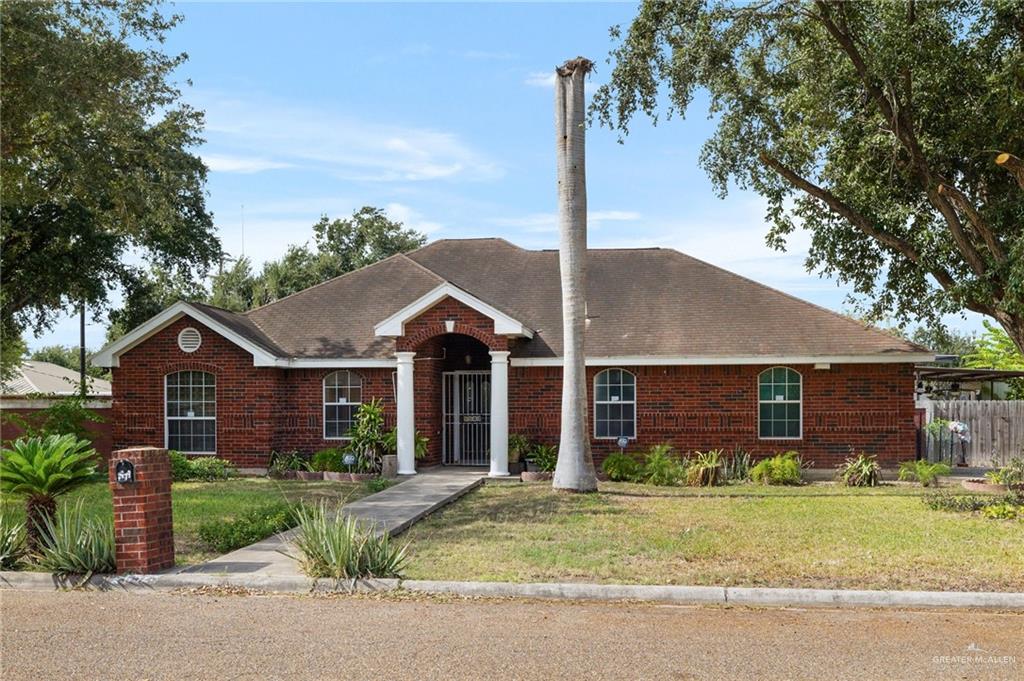 a front view of a house with a garden