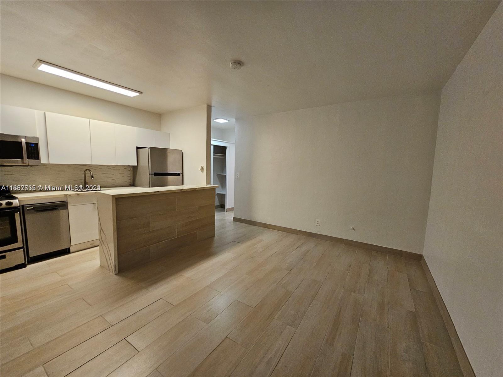 a kitchen with stainless steel appliances a sink and a refrigerator