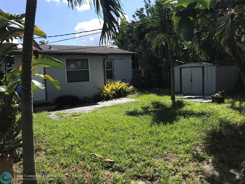 a view of a house with a yard and plants