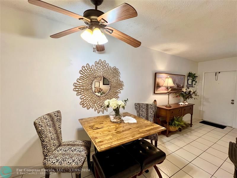 a dining room with furniture and a chandelier