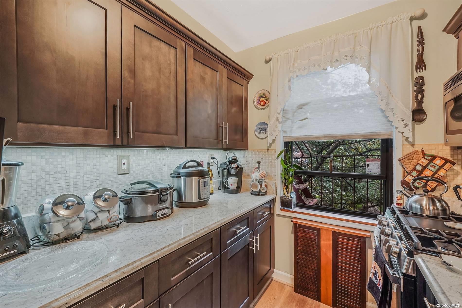 a kitchen with stainless steel appliances wooden cabinets and a stove top oven