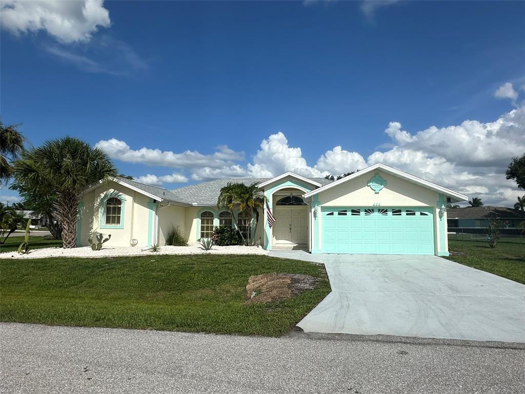 a front view of a house with a yard and garage