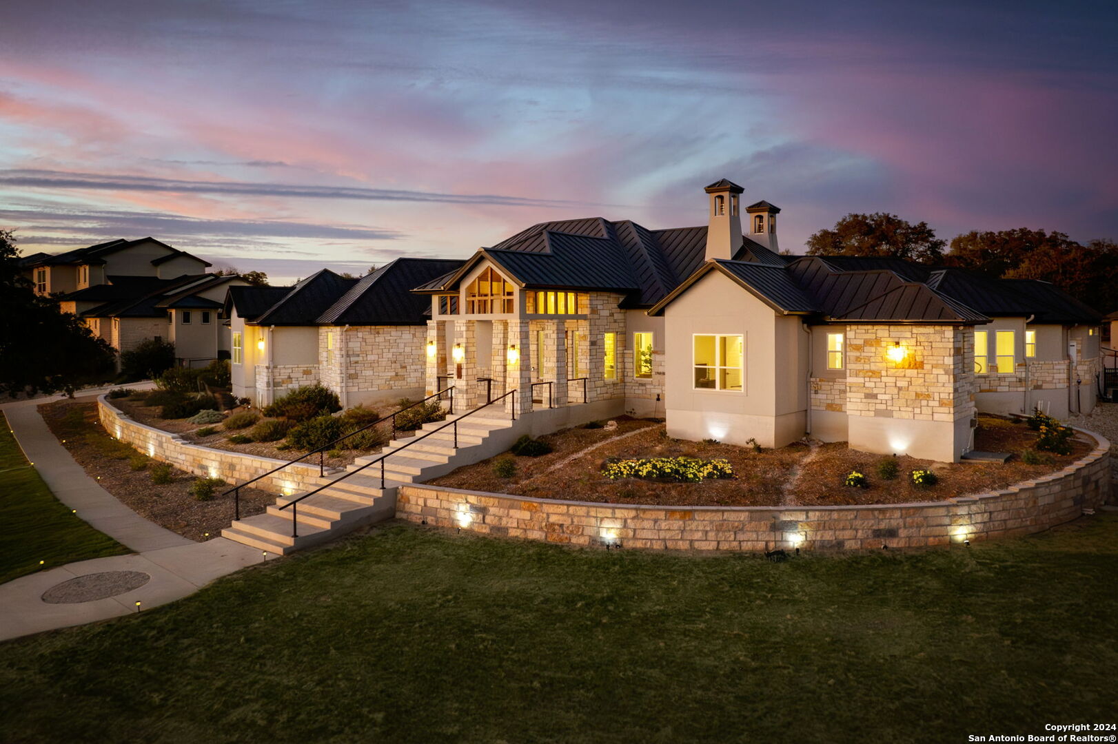 a front view of a house with a garden