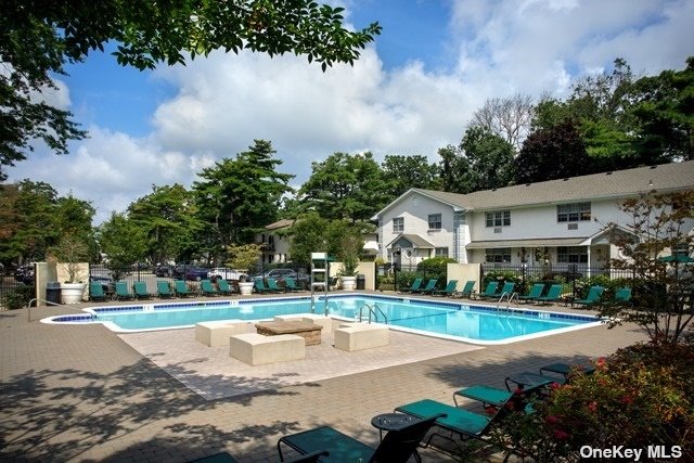 a view of a house with swimming pool and yard