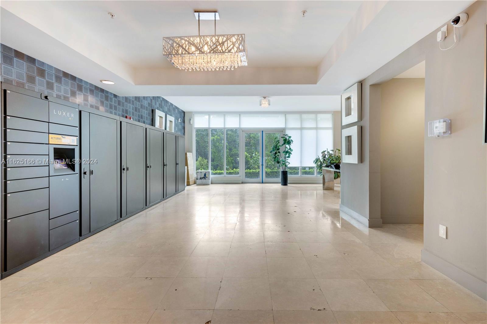 a view of a hallway with furniture and chandelier