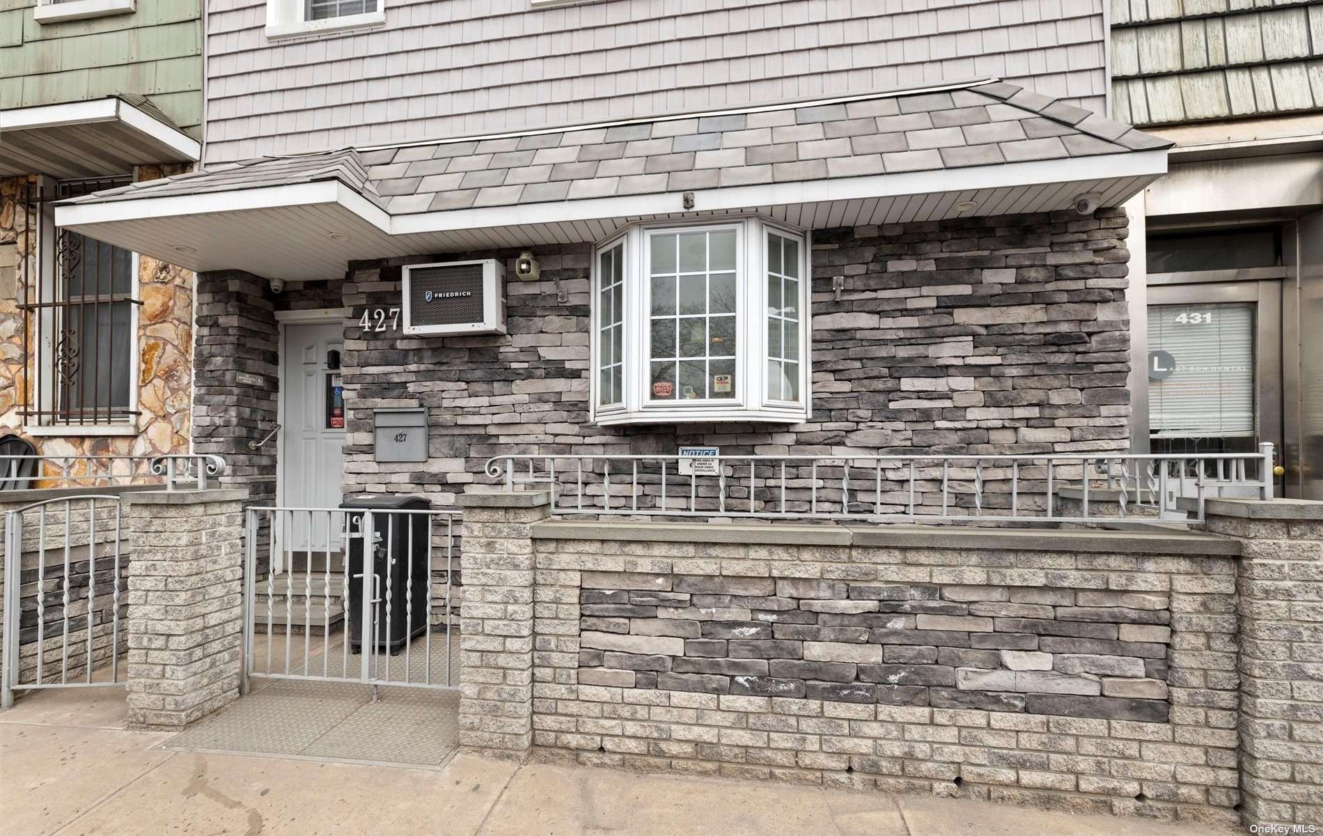 a front view of a house with a brick wall