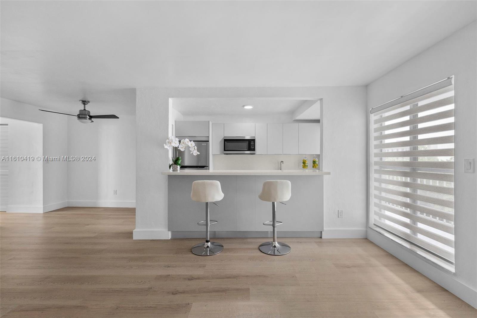 a view of kitchen with stainless steel appliances kitchen island granite countertop a refrigerator and a sink